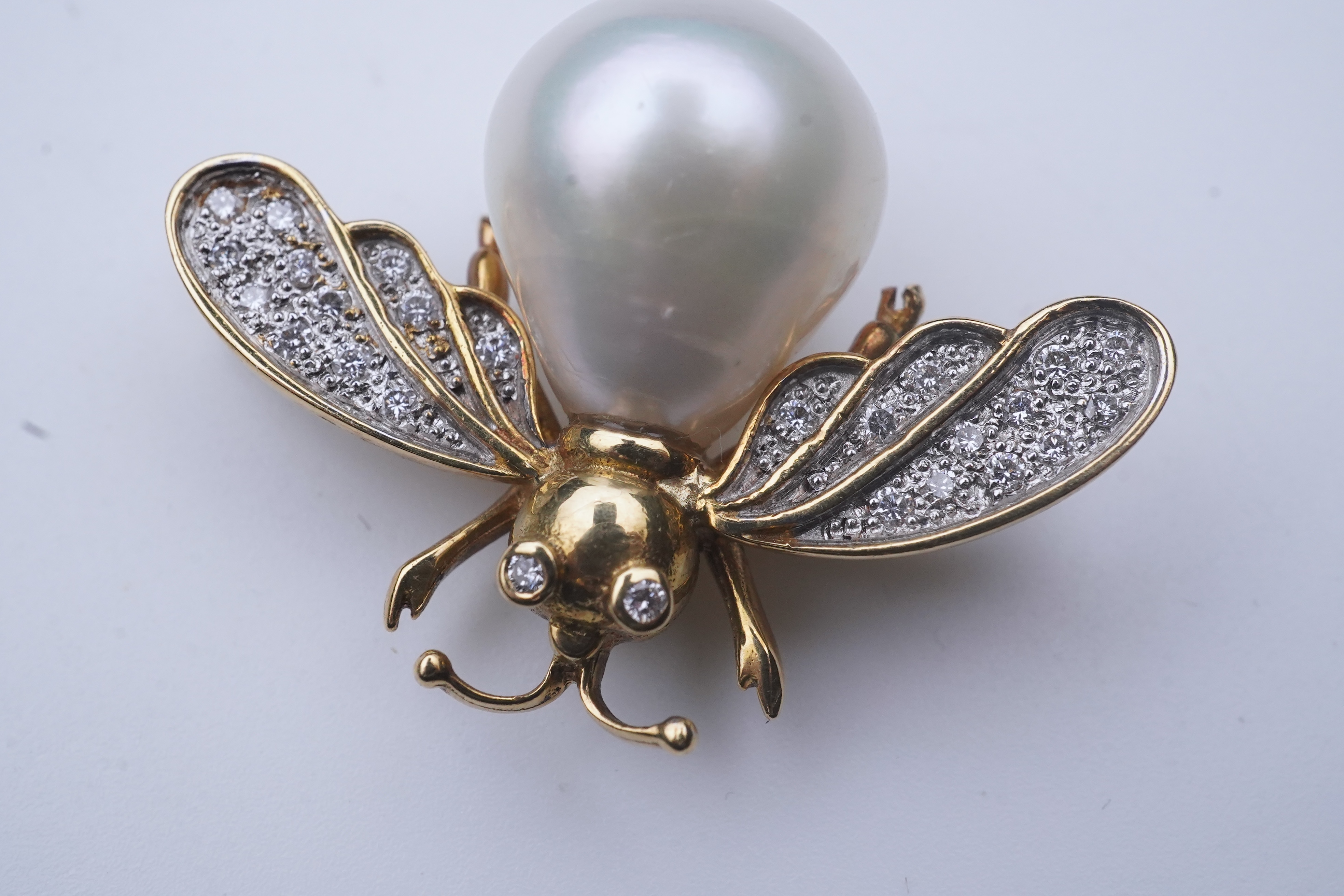 Deakin & Francis, a pair of 18ct gold, cultured pearl and diamond brooches